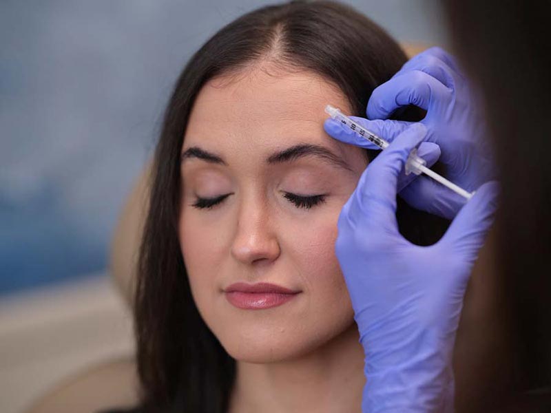 woman getting filler injection in forehead