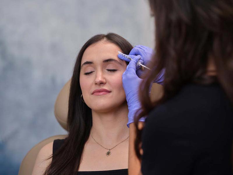 woman getting filler injection in forehead